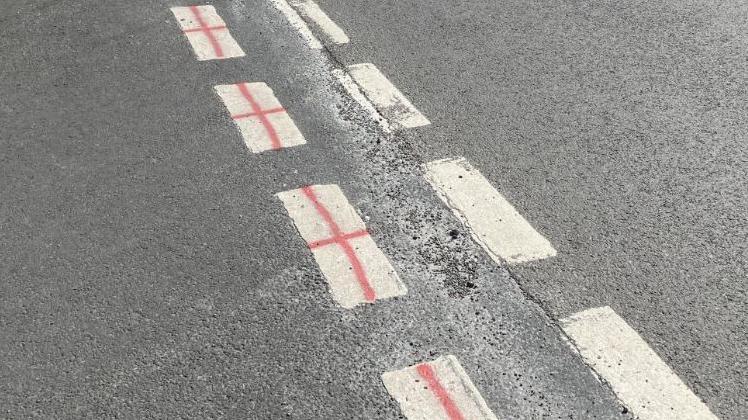 White give way lines painted up with St George's crosses. 