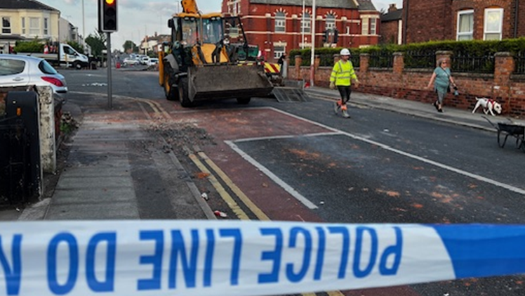 A workman begins the clean-up 