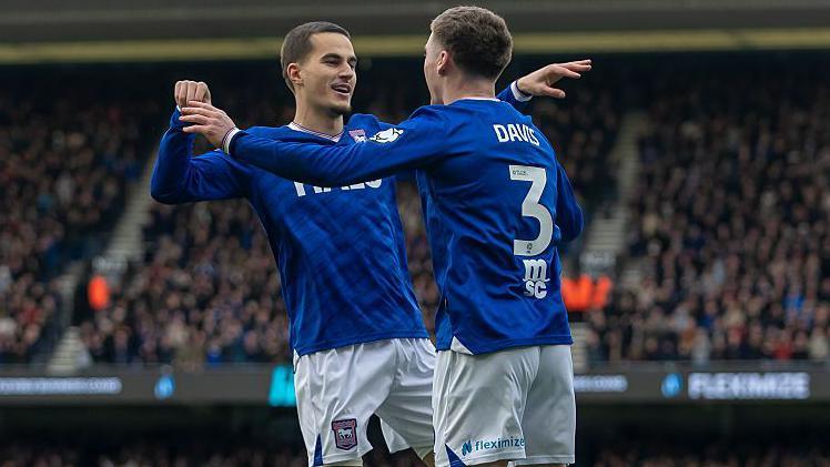 Anis Mehmeti celebrates with Leif Davis 