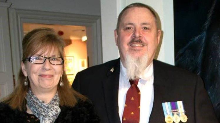 Darren Horsnell wearing blzazing with regimental badge and service medals with late fiancee Tracey Vink.