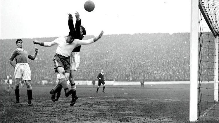 A black and white photograph showing Everton's Dixie Dean in action against Chelsea goalkeeper Millington at Stamford Bridge, London in 1932
