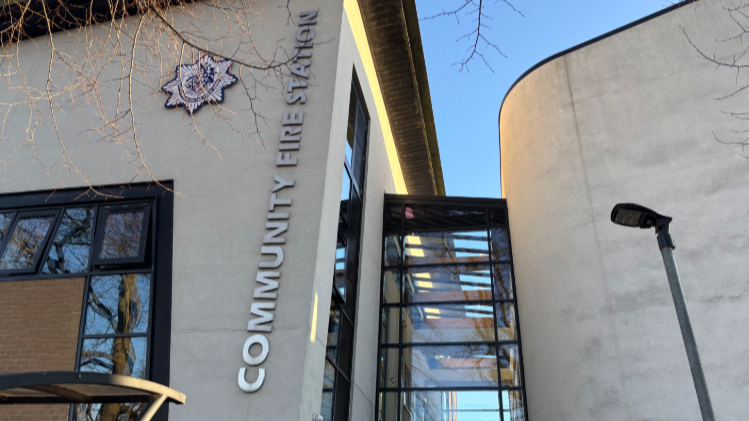 A photo from outside Cheltenham East Community Fire Station showing the front of the building, the fire service logo and a street lamp