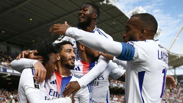 Lyon players celebrate together