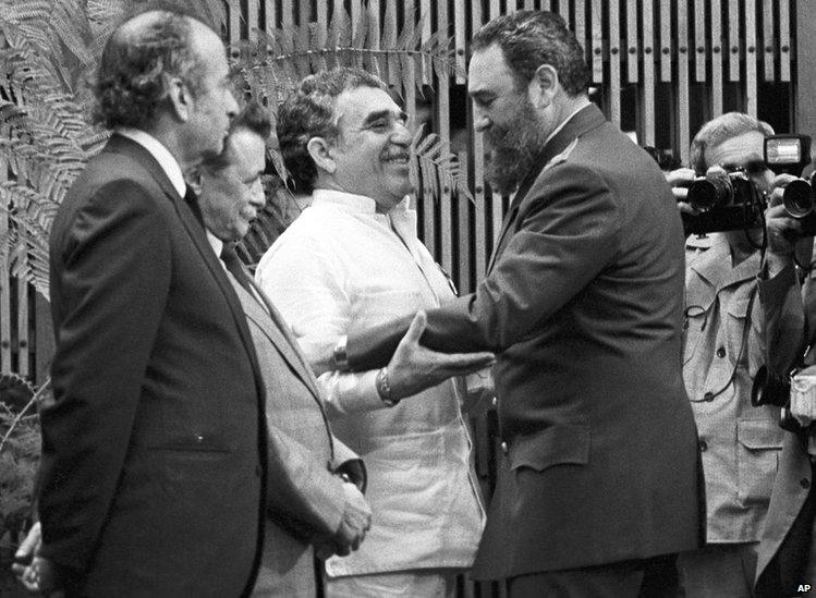 Cuban leader Fidel Castro, right, greets Colombian writer Gabriel Garcia Marquez, centre, during a decoration ceremony in Havana, Cuba, Jan. 6, 1983.