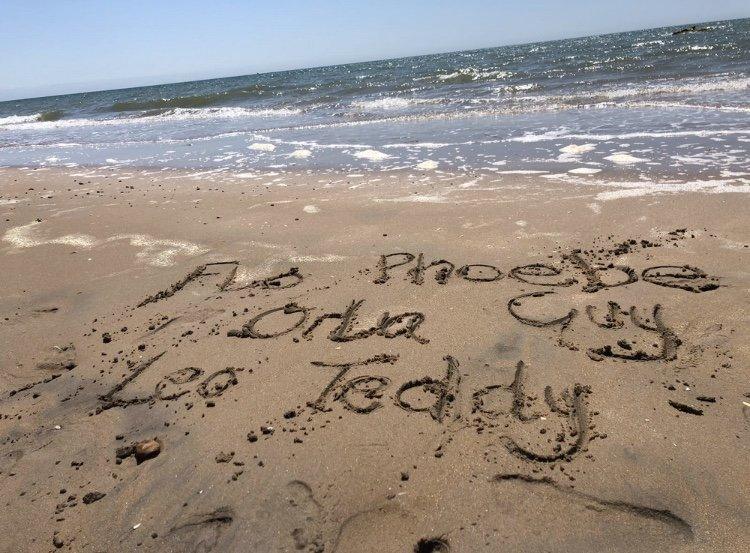 Names written in the sand on a beach