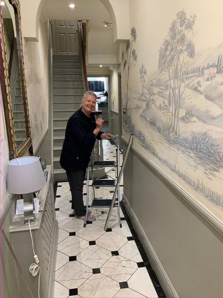 Woman painting in hallway