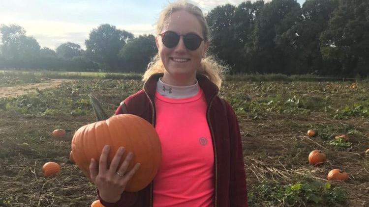 Emma Curtis holding a pumpkin