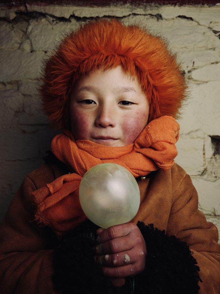 children holding a small balloon