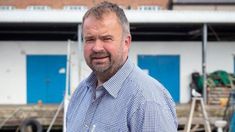 Richard Sim owner of Potted Lobster in Bamburgh standing outside 