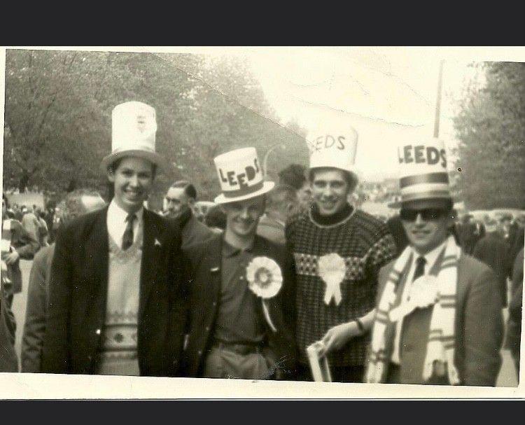 A picture of four men wearing Leeds top hats and rosettes