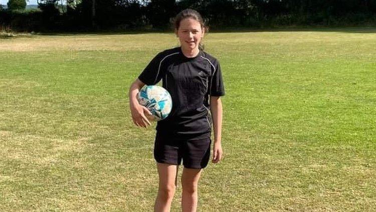 Lacey with a football