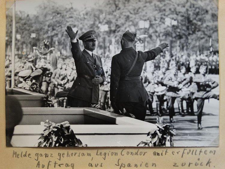 A photograph shows von Richthofen saluting Hitler at a parade in Berlin to celebrate the Condor Legion's homecoming