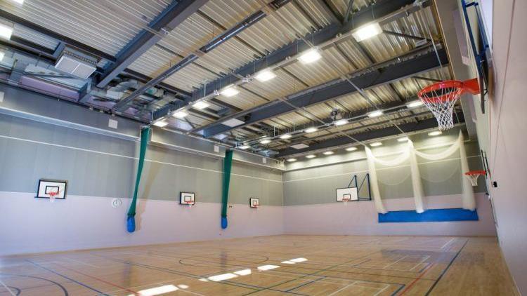 A sports hall with basketball nets.