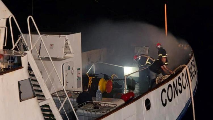 irefighters try to extinguish a fire onboard the Gaza Freedom Flotilla vessel Conscience