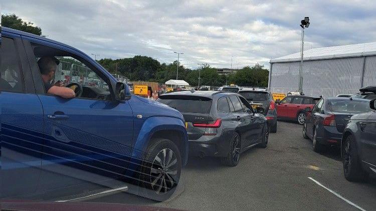 Cars attempt to merge into one queue at Eurotunnel LeShuttle's Folkestone terminal