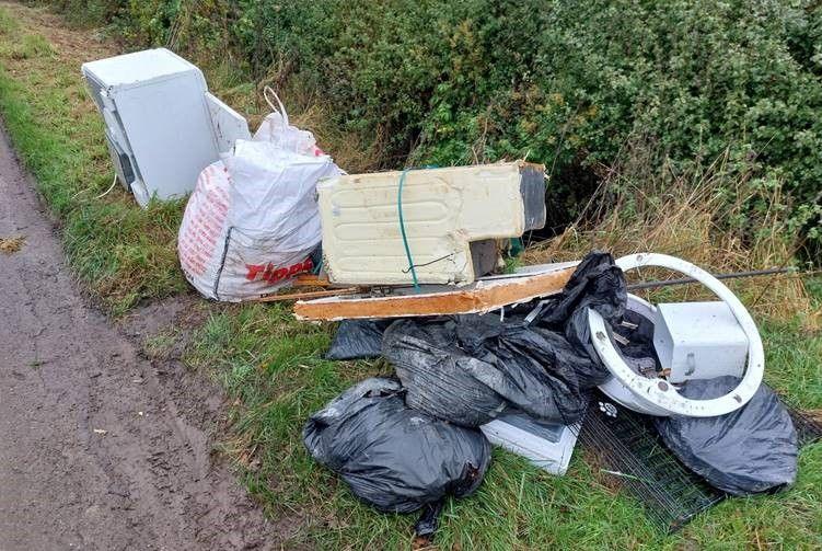 The fridge, builders bag and rubbish viewed from the reverse angle