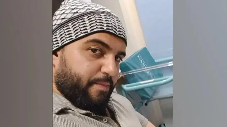 Jihad Al-Shamie shown with a beard and a hat, looking at the camera in an apparent selfie taken from Facebook