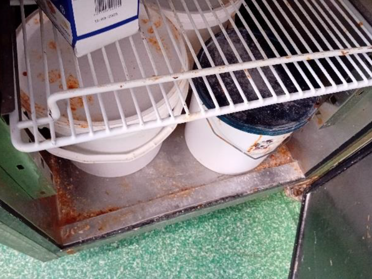 Dirty inside of a fridge in a burger restaurant