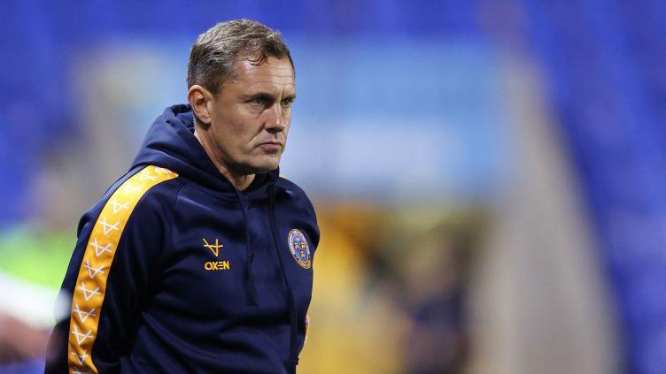 Paul Hurst looks on from the touchline during a game 