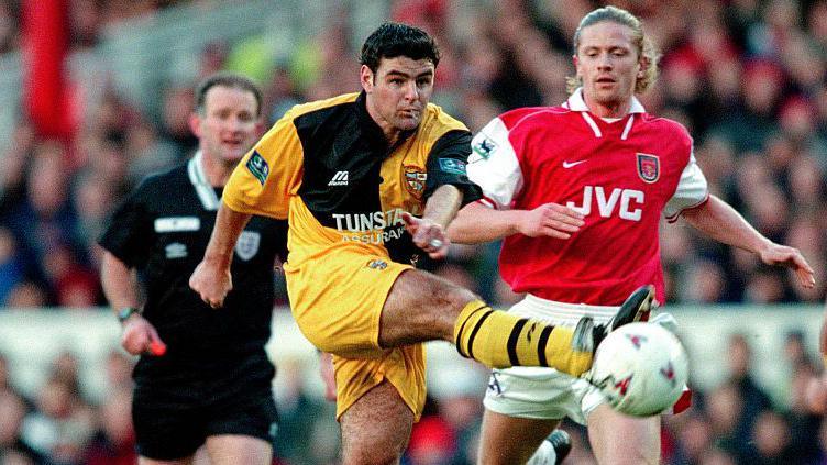 Port Vale and Arsenal players challenge for the ball during their FA Cup tie in January 1998