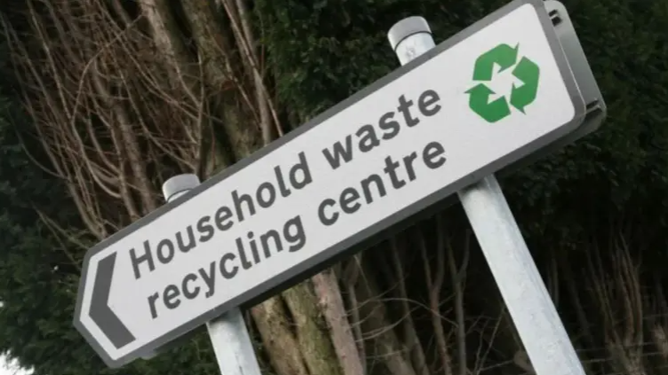 A street sign reading "household waste recycling centre".