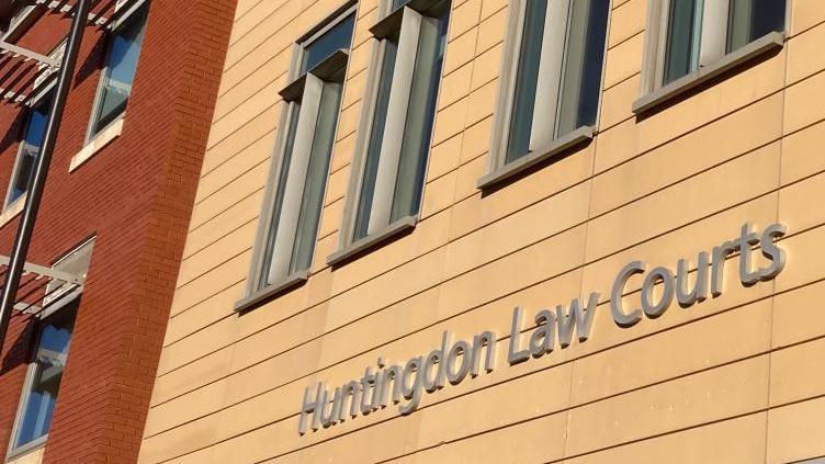 The words "Huntingdon Law Courts" written in silver on the side of a yellow building.