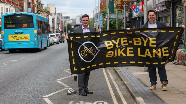 Mayors Chris Cooke and Ben Houchen with a banner supporting scrapping the bike lane.