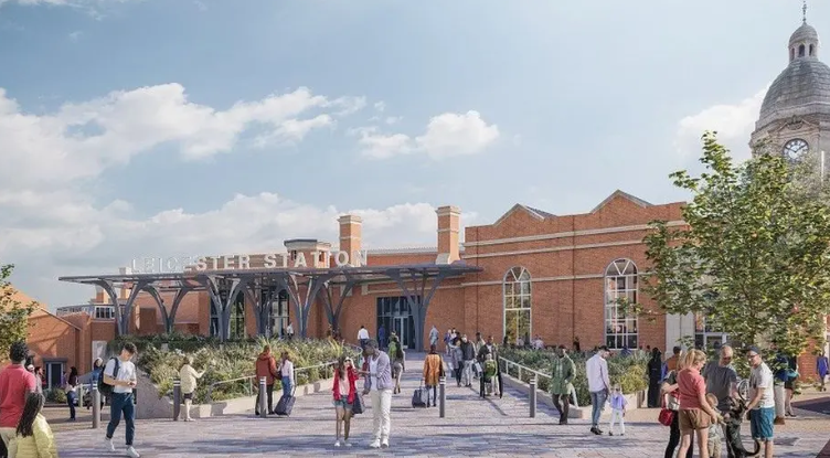 An artist's impression of the planned new entrance to Leicester station with green areas and people standing in a pedestrianised area. 