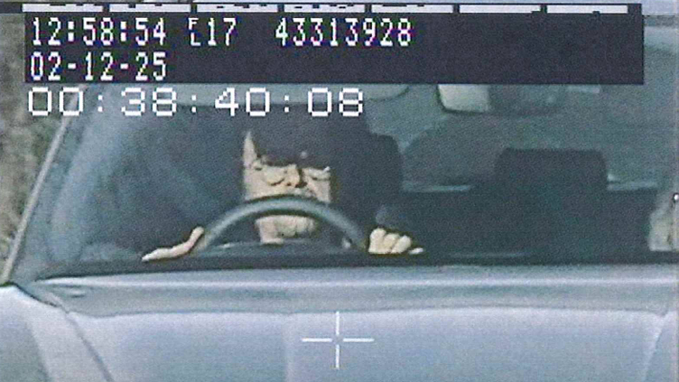 Hammond is captured in a police image driving his Porche. He has glasses on and his sun visor down as he drives.