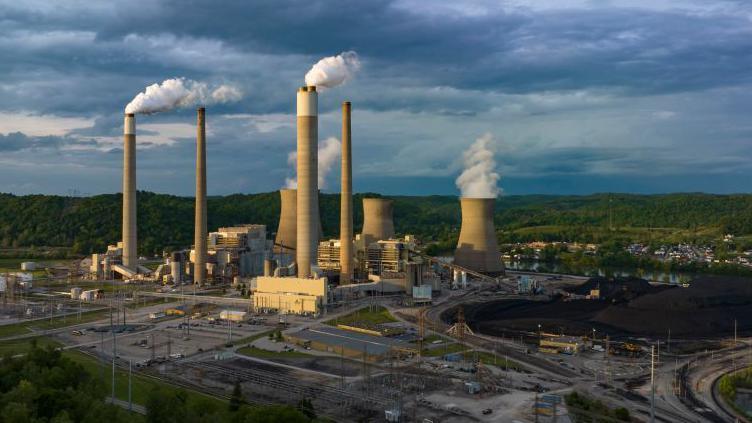 Coal power plant with smoke stacks and cooling towers