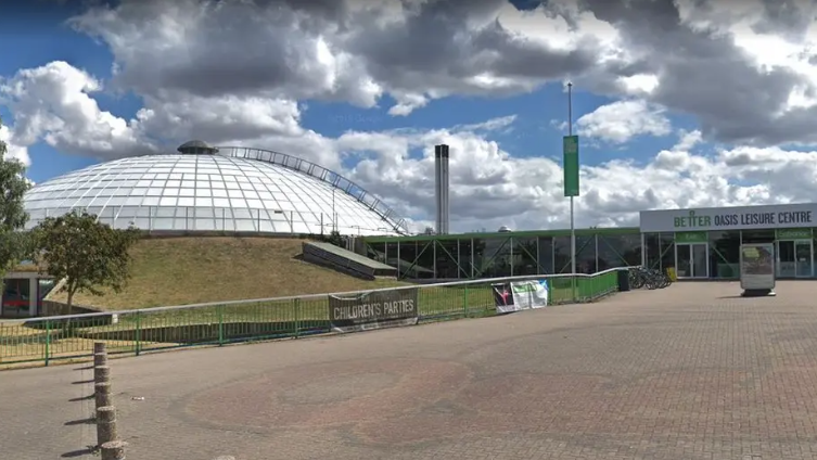 Image shows the Swindon Oasis dome from afar, with a large walking path in front. 