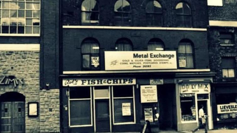 A vintage photograph of The Limit nightclub on West Street, Sheffield next to a fish and chip shop