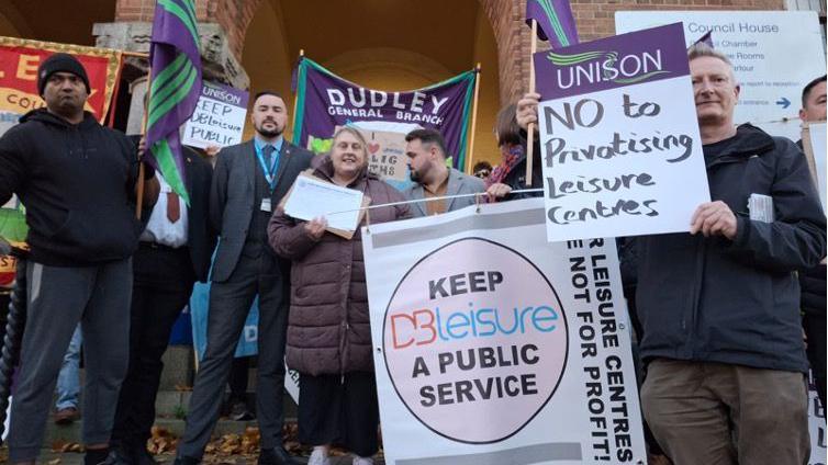 Protesters rallying outside of Dudley Council House with signs that say "no to privatising leisure centres" 