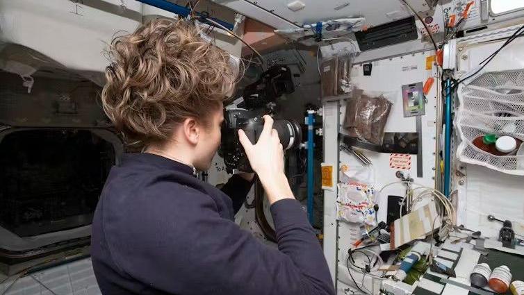 NASA astronaut Kayla Barron photographs an archaeological sample area on the International Space Station