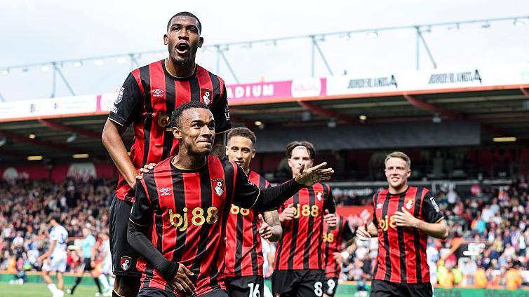 Rayan, Eli Junior Kroupi and Alex Scott celebrate a Bournemouth goal at Vitality Stadium