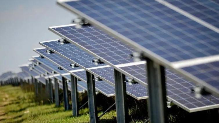 Stock image of solar panels in a field.
