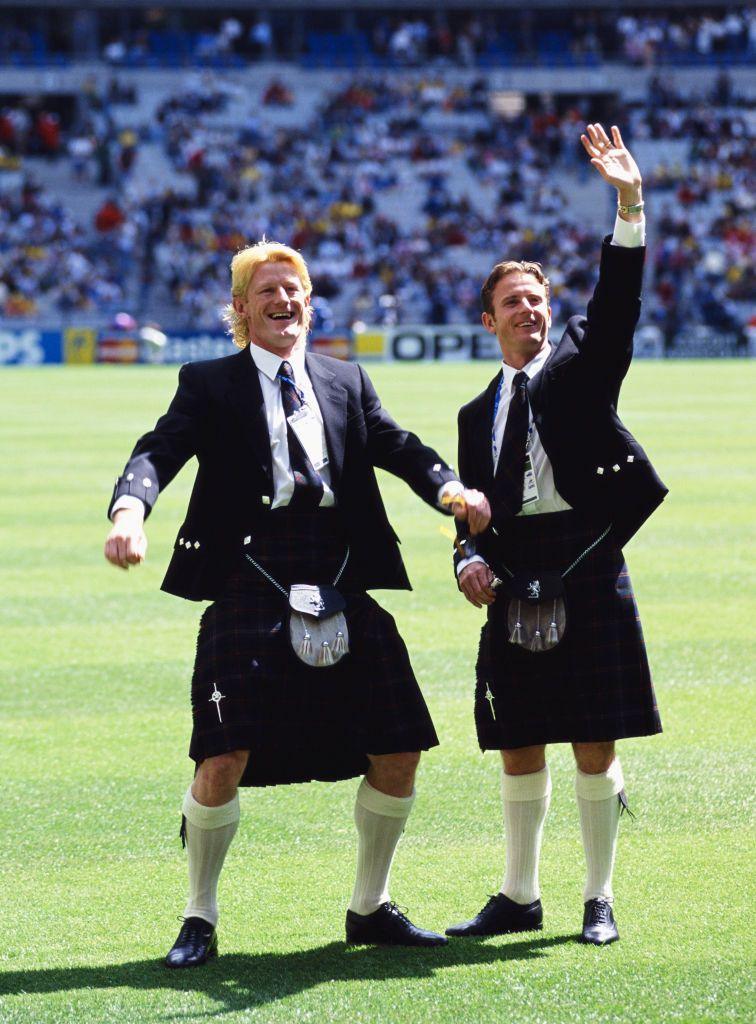 Scotland players Colin Hendry and Kevin Gallacher wave to fans whilst wearing their kilts before the big game in Paris