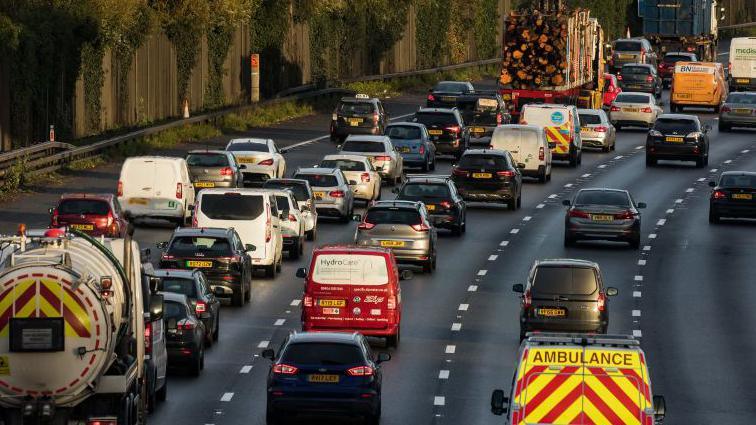 A traffic jam of cars, vans and lorries on the M25. 