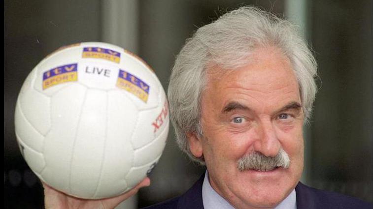 Des Lynam in 1999 holding a football