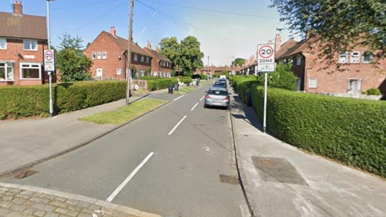 A Google Maps screenshot of Stonebridge Grove, a residential street with on-street parking and houses either side of the narrow road through its centre.