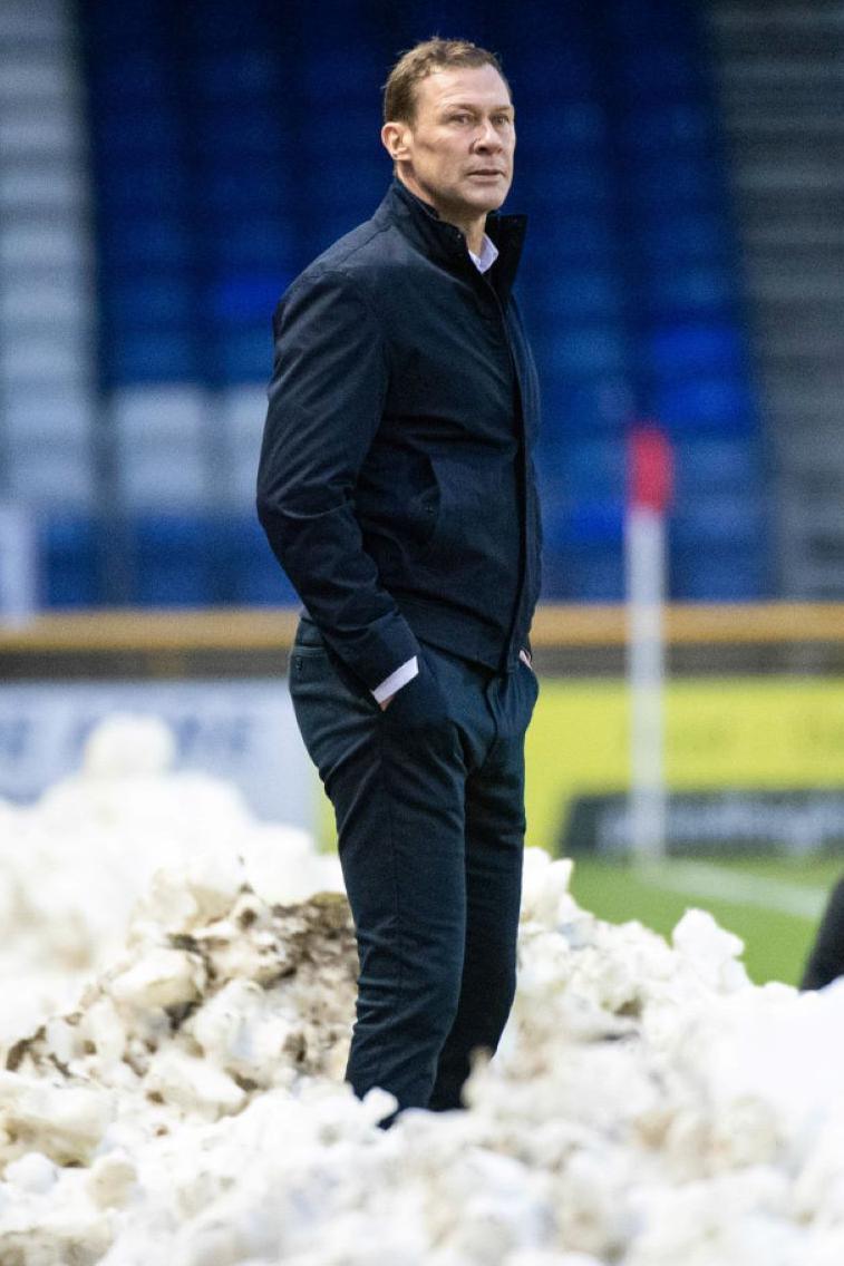 Duncan Ferguson stands with his hands in his pocket in a pile of snow at Inverness' stadium.