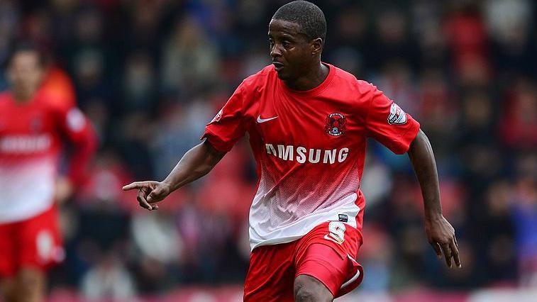 Kevin Lisbie controlling the ball wearing Leyton Orient's 2013 home red and white kit