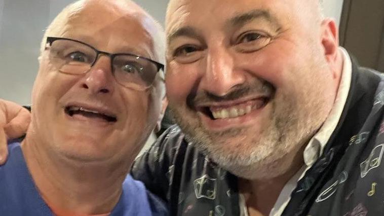 Wynne Evans and brother Huw with arms round each other smiling at the camera