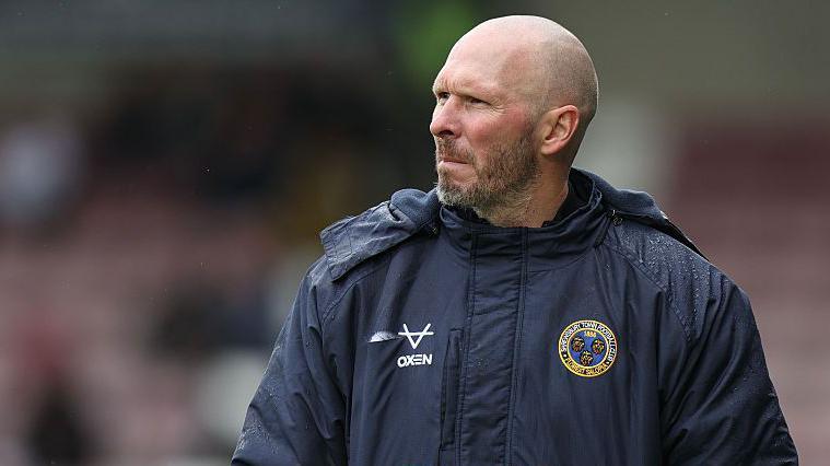 Michael Appleton wearing his Shrewsbury Town club jacket in the touchline
