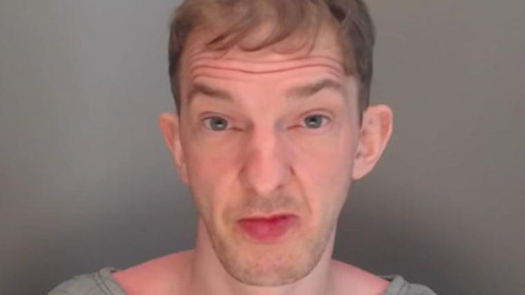 Mugshot of Bates. He has a large chin and lips and short fair hair.