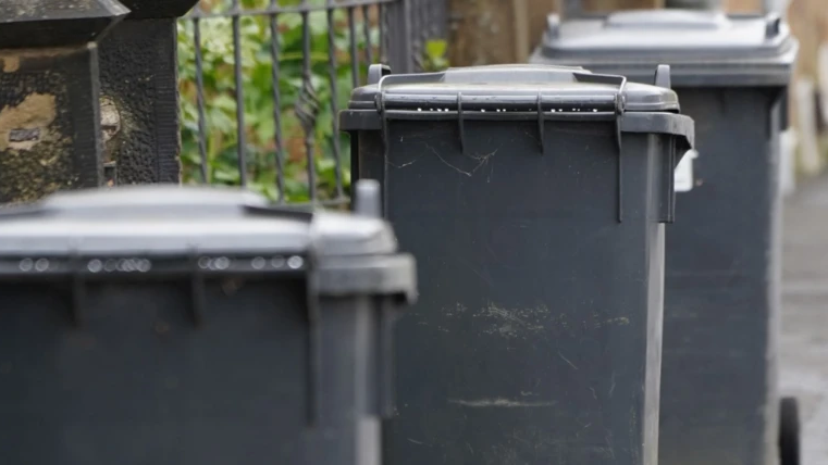 An image of three black bins lined up in a row