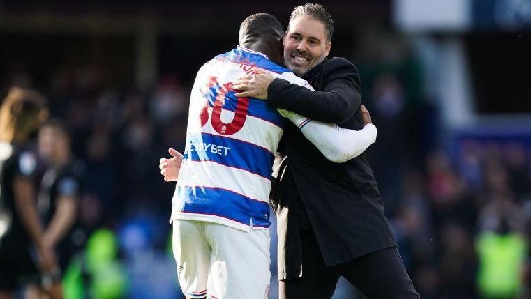 QPR's Marti Cifuentes [right] hugs Sinclair Armstrong
