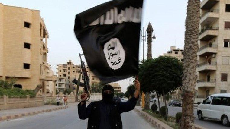 Isil flag-bearer in Raqqa, Syria, June 2014