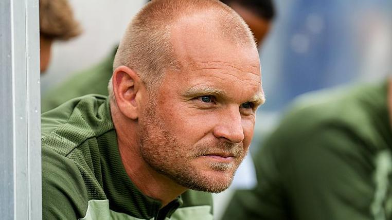 Liam Manning in the dugout
