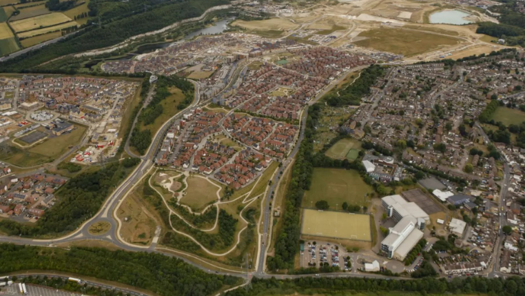 An aerial view shows hundreds homes in a huge sprawling development.